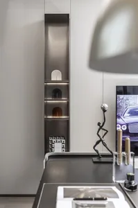 A modern office space featuring metal shelving units with illuminated compartments.