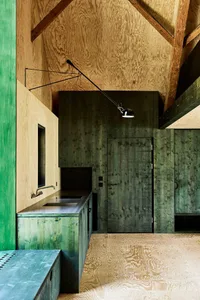 Minimalist small residential house with wood interior and exterior. Interior has a modernist design with clean lines and open