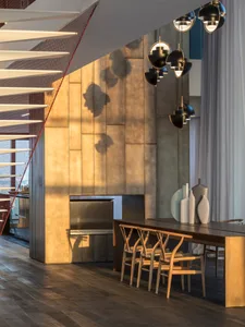 Modern dining room with geometric lighting fixtures and metallic walls