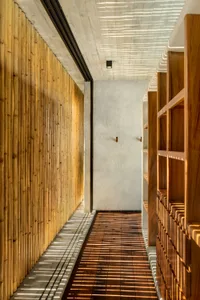 A modern corridor interior with bamboo-laminated board walls and hardwood floors.