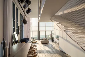 Modern living room featuring exposed wood flooring, large windows, and a sofa with a table in front of it.