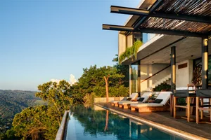 Luxurious modern residential architecture featuring concrete and wooden elements.