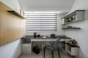 Minimalist home office featuring concrete and glass materials with a desk, chair, and shelves.