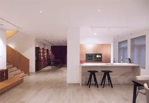 Modern interior design featuring minimalist style with wood, marble, and metal accents.