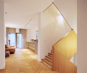 A modern residential interior featuring a wooden hardwood floor.