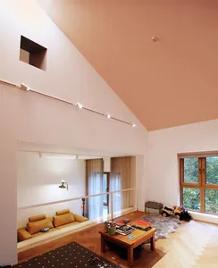 A modern living room with soft-touch wooden furniture, comfortable seating, and a cozy atmosphere.