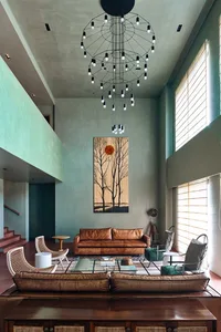 Modern living room featuring a leather couch, wood coffee table, and contemporary art on the wall.
