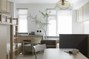 A modern residential space featuring light wood, glass, and marble elements.