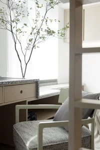 A modern home office featuring a terrazzo countertop and minimalist furniture.
