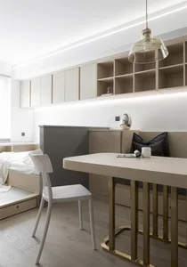 A modern minimalist bedroom featuring sleek, contemporary furniture and a clean, uncluttered design.