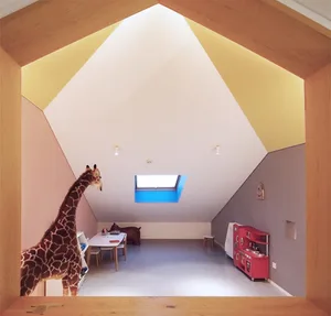 A modern playroom with multi-color painted walls and a giraffe toy