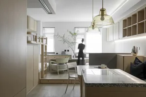 Contemporary residential interior with marble kitchen countertop, glass pendant lights, and wooden furnishings.