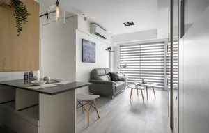 A modern living room featuring a glass coffee table with minimalist design and neutral color palette.
