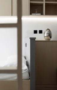 A modern minimalist bedroom featuring wood and metal materials.