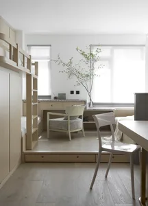 Minimalist bedroom featuring wood furniture and natural light.