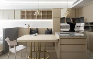 Modern minimalist kitchen featuring wooden cabinets, marble countertop, and metal accents.