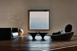 A minimalist living space featuring wooden furniture, a large window with a view of a forest, and a black coffee table with t