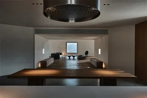 Modern minimalist lounge area with wooden flooring and furniture.