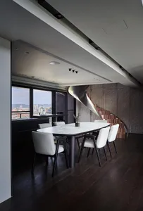 Modern dining room featuring a marble table and luxury steel accents