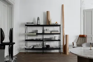 Modern living room featuring black furniture, white walls, and minimalist design.