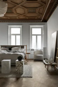 Modern minimalist bedroom with a luxurious marble floor, wooden accents, and a soothing color palette focused on white and so