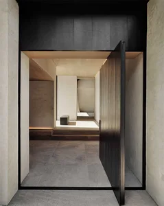 Modern entrance with concrete flooring and wooden door.
