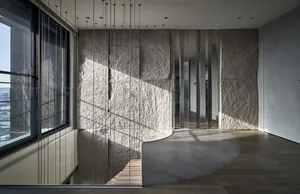 Modern minimalist interior featuring stainless steel accents and architectural elements.
