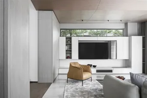 A modern living room with white concrete walls, a marble floor, and minimalist furniture.