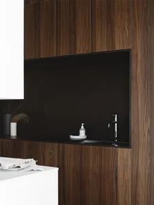 Modern bathroom with minimalist design featuring dark wooden cabinets and a sleek, black sink.