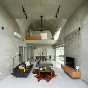 Contemporary living room interior with polished concrete walls and furniture.