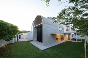 Modern house with a concrete exterior and large windows.