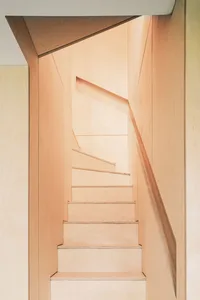 A modern wooden staircase interior with sleek, minimalist design.