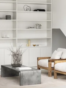 Modern living room with concrete furniture and minimalist decor.