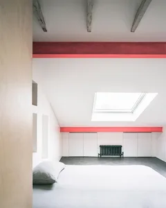 Minimalist bedroom featuring white furniture, concrete floors, and a skylight.