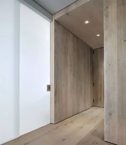 An interior space with minimalist design featuring wooden walls and floor.