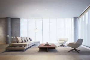 Modern living room featuring concrete, glass, and furniture.