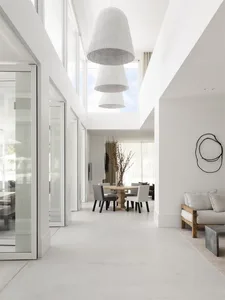 A modern minimalist residential interior with concrete and wood materials.