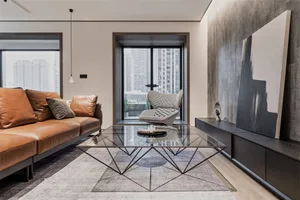 A modern minimalist living room featuring wood furniture, a glass coffee table, and a view of urban skyscrapers outside.