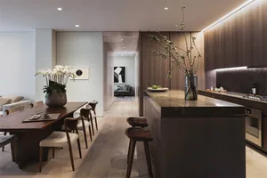 Modern kitchen with wooden elements and minimalist decor.