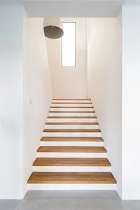 A modern staircase made of white wood, featuring a minimalist design.
