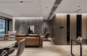 A modern living and dining room with concrete, wood, and leather materials.