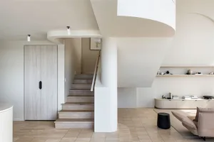 A minimalist living room with a neutral color palette and modern design elements.