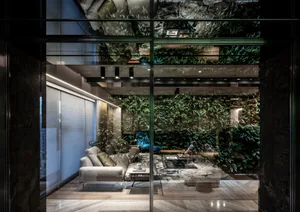 Modern living room featuring wooden floors and a greenery-covered wall.