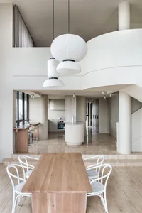 Modern, minimalist kitchen featuring wooden materials and clean lines.