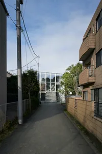 A modern building exterior featuring a combination of aluminum, glass, and concrete materials.