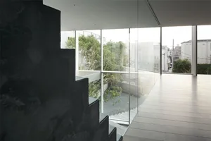 A modern house with large glass walls and a minimalist design.