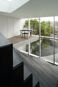 A modern interior design featuring metal, concrete, and glass structures.