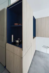 Modern industrial kitchen with wooden cabinets and a dark blue interior