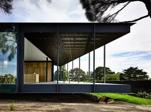 Modern architectural design featuring glass and wooden elements.