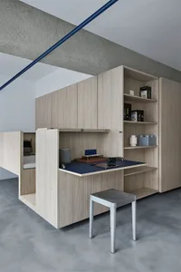 A modern workspace with wooden furniture and shelves.